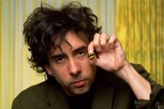 WEST HOLLYWOOD, CA - 1989:  Director of the first "Batman" movie and "Batman Returns," Tim Burton, proudly displays a Batman pin during a 1989 West Hollywood, California, photo portrait session. In addition to his "Batman" fame, Burton went on to direct such eclectic hits as "Ed Wood," "Beetle Juice," "Edward Scissorhands," and the "Corpse Bride".(Photo by George Rose/Getty Images)